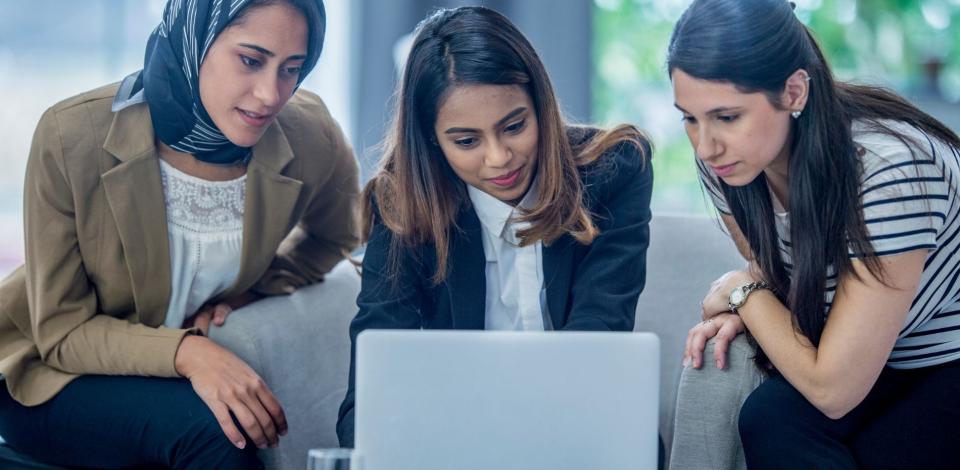 Three women in financial technology sector collaborating over computer screen