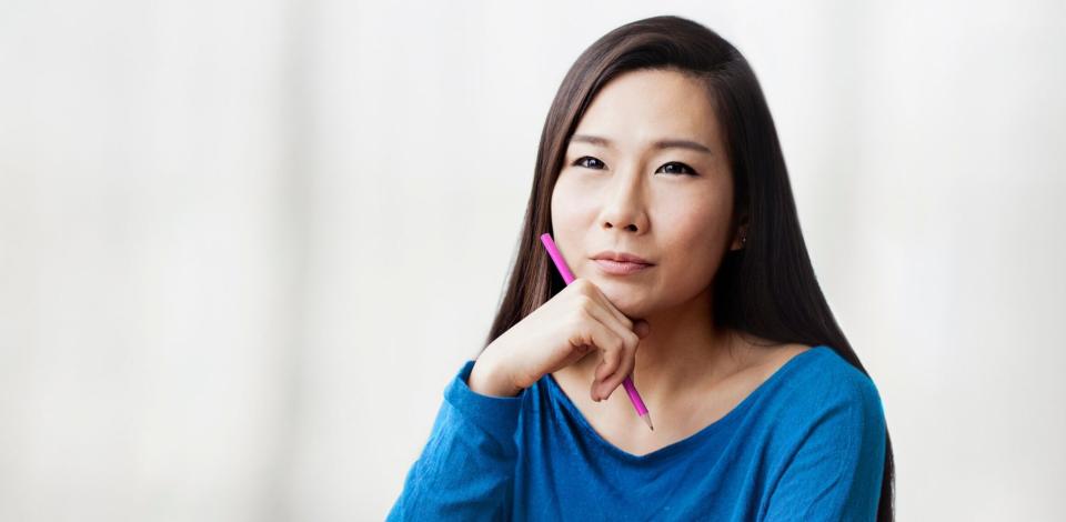 Woman sitting and thinking about her professional goals and how to achieve them.