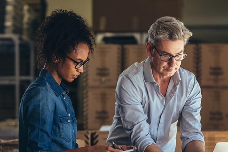 Supply chain professionals collaborating in warehouse