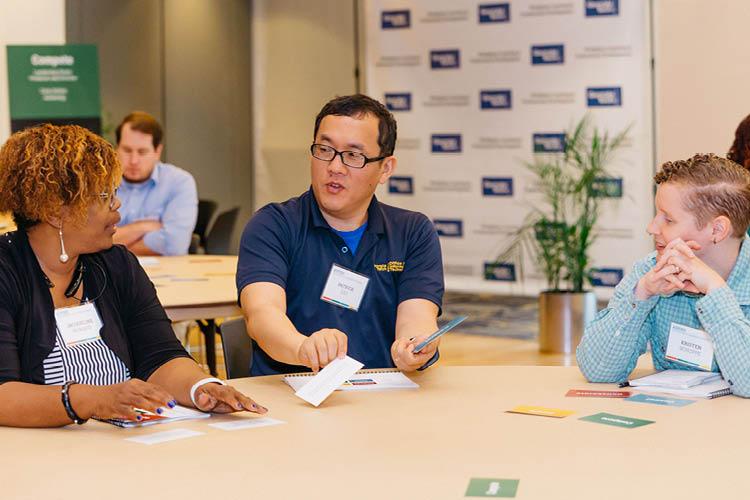 ASPIRE participants sitting around a table during a discussion