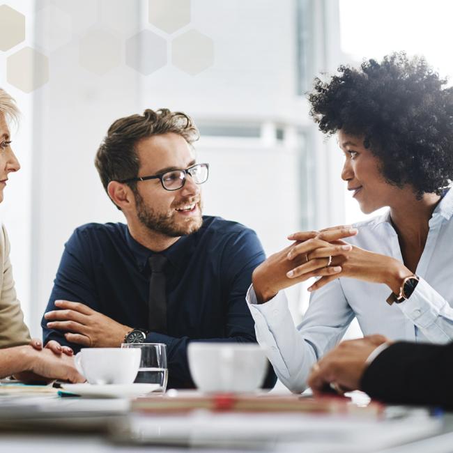 Employees meeting around table to discuss workplace values